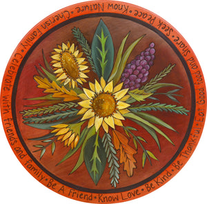 Sticks Handmade 20"D lazy susan with lovely rich hues and late summer sunflower bouquet at the center