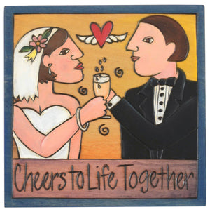 Sticks handmade wall plaque with "Cheers to Life Together" quote and couple with champagne