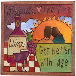 Sticks handmade wall plaque with "Friends, like fine wine, get better with age" quote and sunset picnic imagery