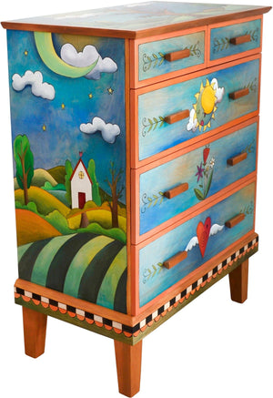 Tall Dresser –  This predominately blue dresser features a tree of life in the landscape design