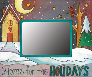 "Home for the holidays" frame with winter landscape and heart home in the quiet of night