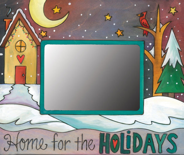 "Home for the holidays" frame with winter landscape and heart home in the quiet of night