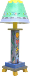 Milled Candlestick Lamp –  Cool-toned stacked icon lamp base motif with a sweet shade filled with flowers and scallops