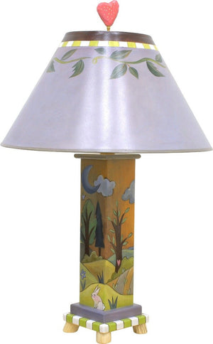 Contemporary lamp with simple vine shade and rolling hills landscape on its base, front side