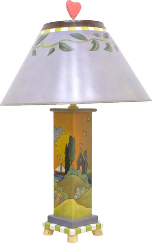 Contemporary lamp with simple vine shade and rolling hills landscape on its base, back view