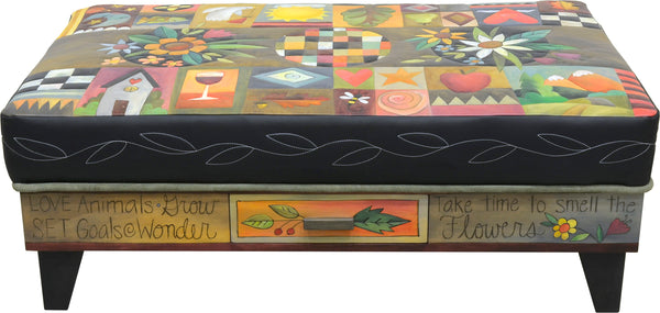 Crazy quilt ottoman motif with center floral sprays and a contrasting stitched vine around its edge