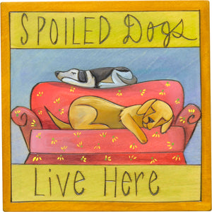 "Spoiled dogs live here" plaque with two sleepy dogs on a couch design