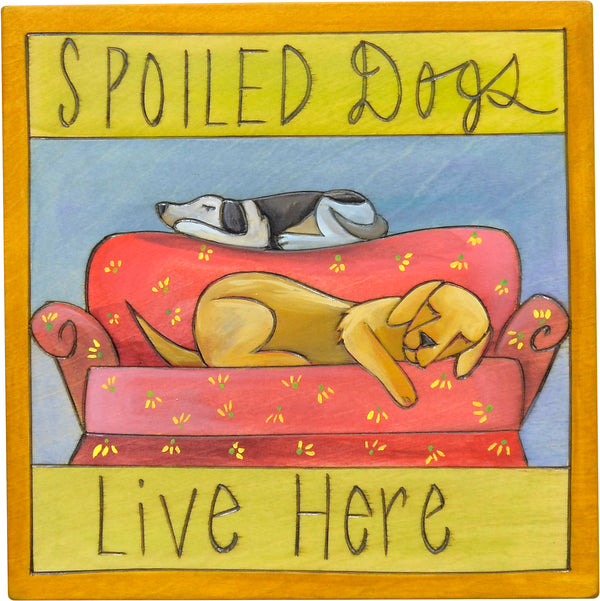 "Spoiled dogs live here" plaque with two sleepy dogs on a couch design