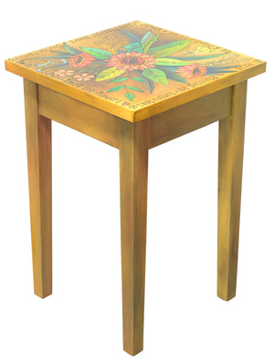 Beautiful natural wood toned end table with pink floral spray on top
