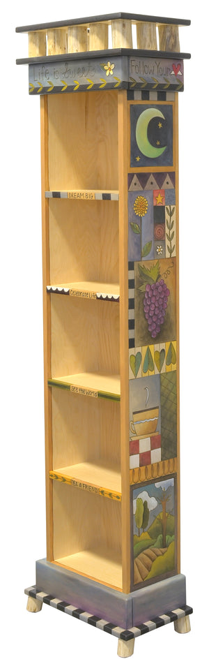 Tall Skinny Bookcase –  "Live is sweet" bookcase with short, sweet phrases down fronts of shelves and crazy quilt designs down the sides main view