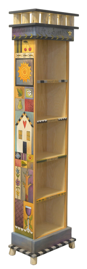 Tall Skinny Bookcase –  "Live is sweet" bookcase with short, sweet phrases down fronts of shelves and crazy quilt designs down the sides side view