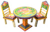 36" Round Dining Table – Warm-toned landscape themed dining table with coordinating sun and moon log chairs view with coordinating chairs