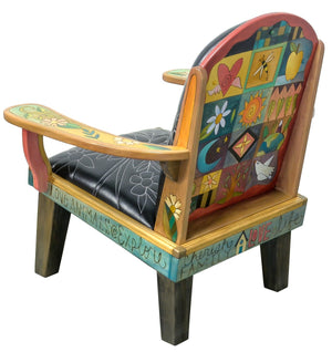 Friedrich's Chair and Matching Ottoman – Black and white floral leather seat and patchwork ottoman design, with coordinating colorful patchwork design filling the back of the oversized chair back view