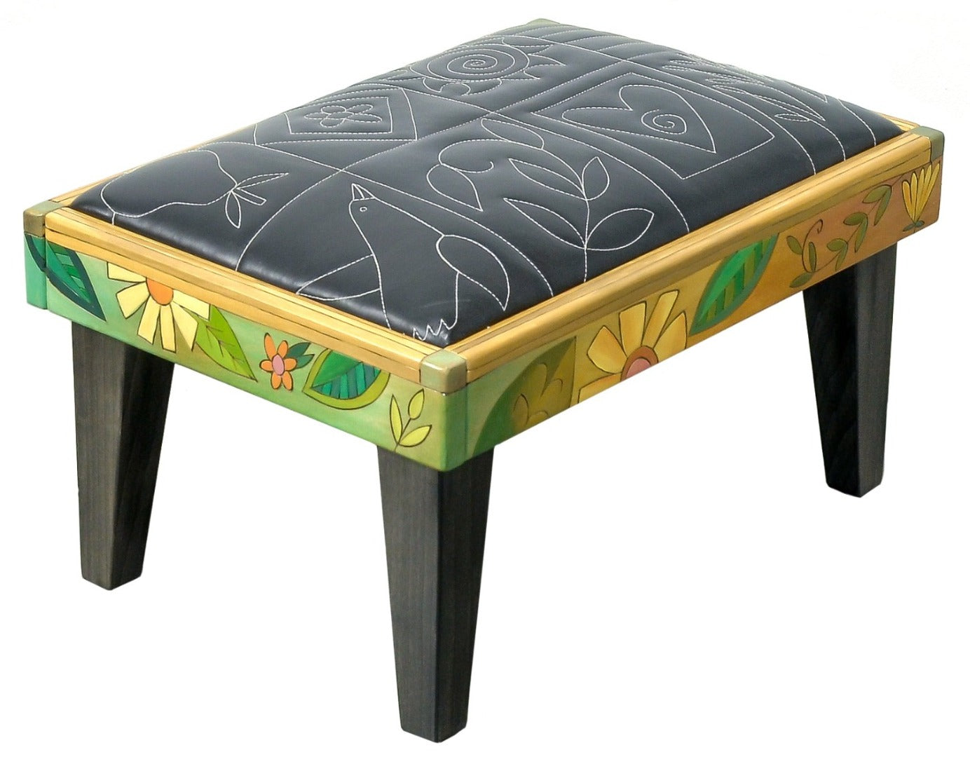 Friedrich's Chair and Matching Ottoman – Black and white floral leather seat and patchwork ottoman design, with coordinating colorful patchwork design filling the back of the oversized chair ottoman front view