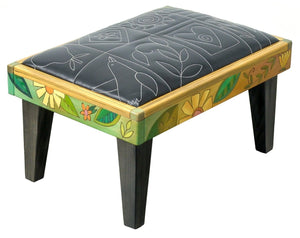 Friedrich's Chair and Matching Ottoman – Black and white floral leather seat and patchwork ottoman design, with coordinating colorful patchwork design filling the back of the oversized chair ottoman front view