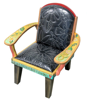 Friedrich's Chair and Matching Ottoman – Black and white floral leather seat and patchwork ottoman design, with coordinating colorful patchwork design filling the back of the oversized chair top view