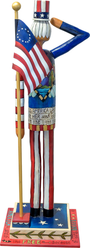 Large Uncle Sam Sculpture – Saluting Uncle Sam at attention in front of a Betsy Ross flag back view