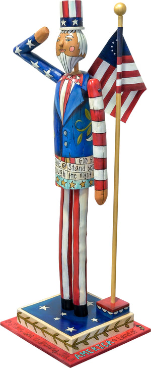 Large Uncle Sam Sculpture – Saluting Uncle Sam at attention in front of a Betsy Ross flag side view