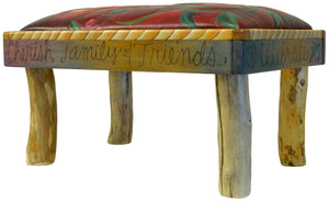 Ottoman – Lovely red "live life to the fullest" ottoman with a floral vine and rope border edge plus natural log legs that tie the whole look together side view