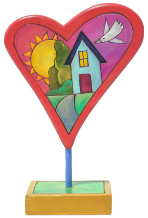 hand painted heart sculpture with house landscape