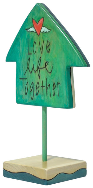 Star Sculpture – "Love Life Together" Table stop shaped sculpture of a couple standing in front of a house. Back view