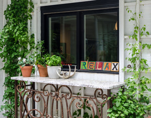 Example of Sincerely, Sticks "X" alphabet letter plaque to spell out Relax on a window sill