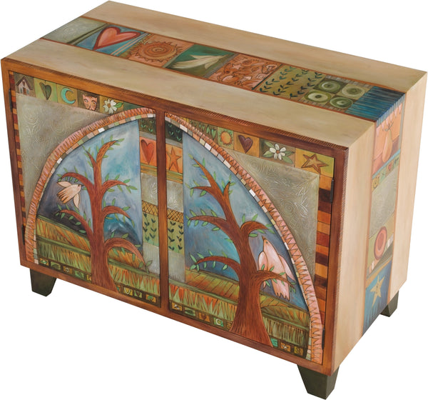 Media Buffet –  Elegant and neutral media cabinet with tree of life motifs and colorful block icons throughout