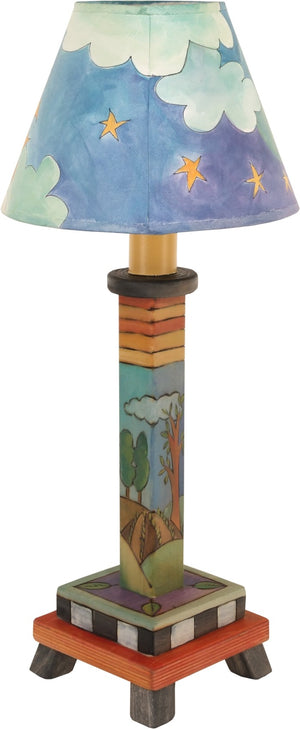 Milled Candlestick Lamp –  The cute landscape base and sky shade design on this lamp makes it perfect for a nightstand