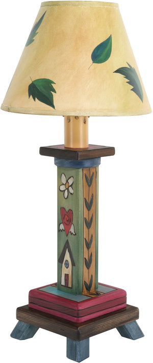 Milled Candlestick Lamp –  Lamp with a leafy shade design and stacked Sticks icons fill the base