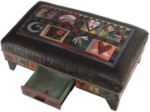 Ottoman with Drawer –  A crazy quilt motif painted in an elegant palette beautifully pops off the black leather top view with drawer open