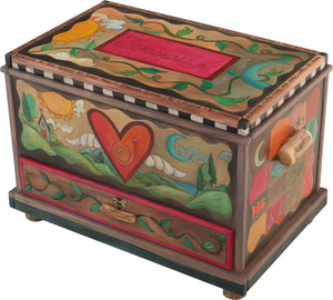 Chest with Drawer – Beautiful heart with wings floating in a landscape with a twisting vine on its lid and patchwork motifs on the sides main view