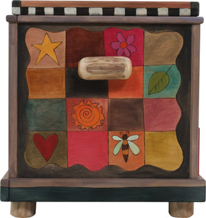 Chest with Drawer – Beautiful heart with wings floating in a landscape with a twisting vine on its lid and patchwork motifs on the sides left side view