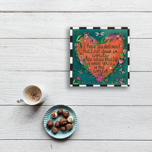 "Love Note" Plaque – "I hope you don't mind" love quote within a flower shaped heart motif displayed on a white tabletop