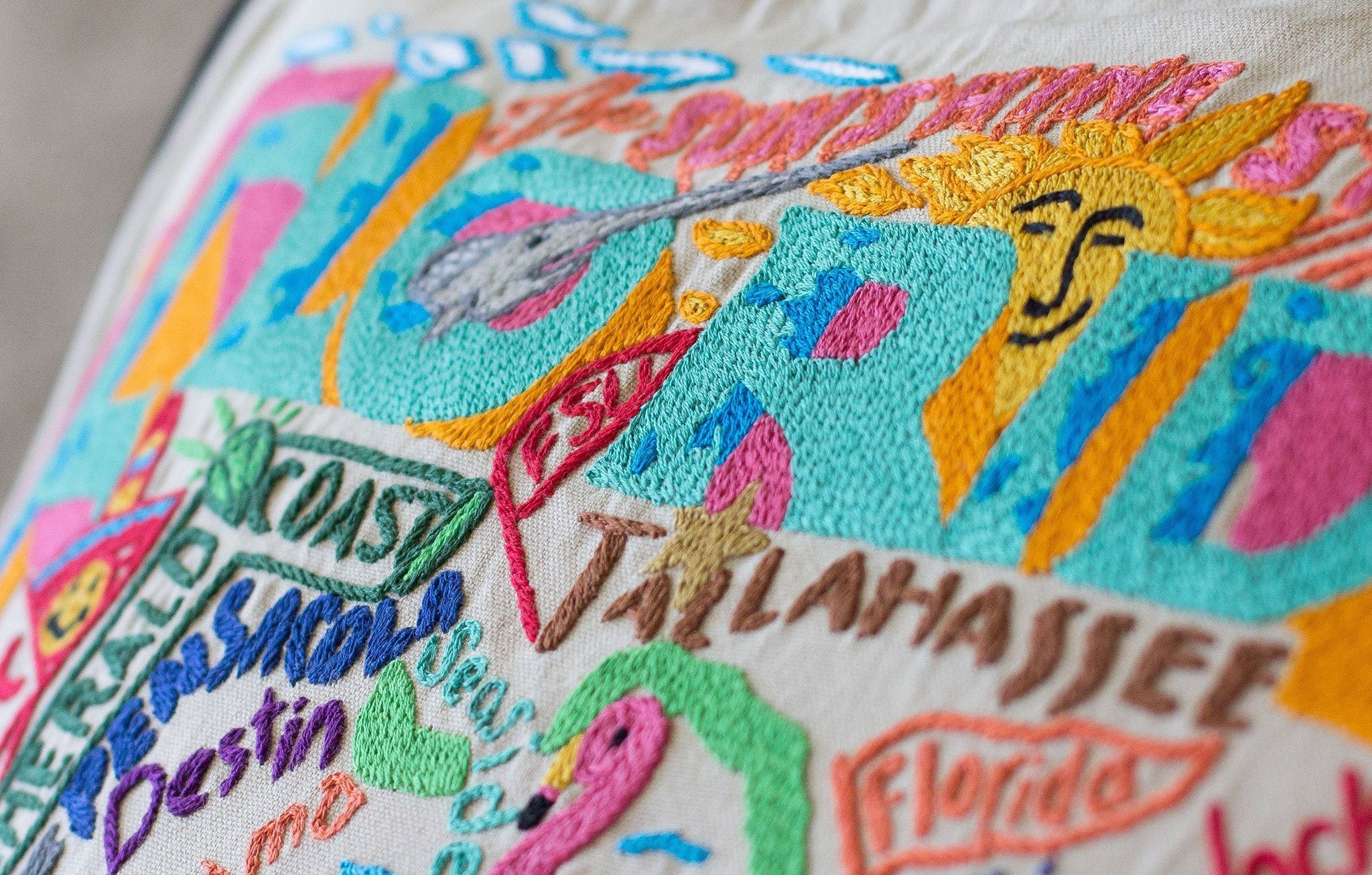 Florida Hand-Embroidered Pillow -  This original design celebrates the beautiful sunshine state of Florida. From the Keys to Pensacola, Tampa to Palm Beach, Flamingos to Alligators...and we'd never forget the Mouth of the Rat (Boca Raton)! Ha, ha! What a great state!