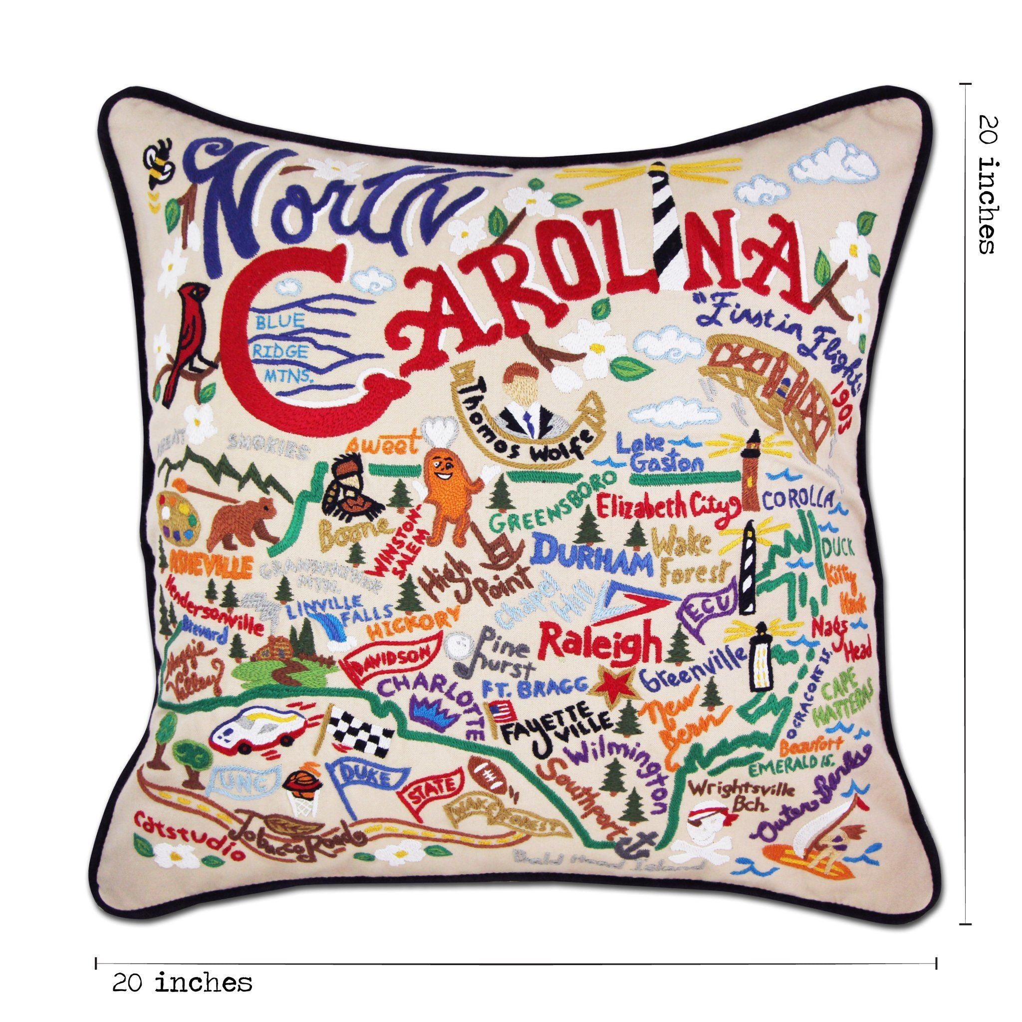 North Carolina Hand-Embroidered Pillow -  What a beautiful state! This original design celebrates the state of North Carolina—from Cape Fear to Asheville to Duck to Kitty Hawk, where man's first flight took place.