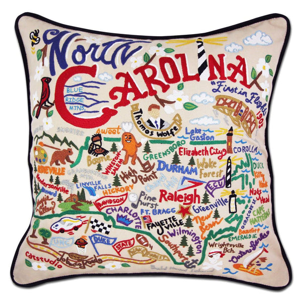 North Carolina Hand-Embroidered Pillow -  What a beautiful state! This original design celebrates the state of North Carolina—from Cape Fear to Asheville to Duck to Kitty Hawk, where man's first flight took place.